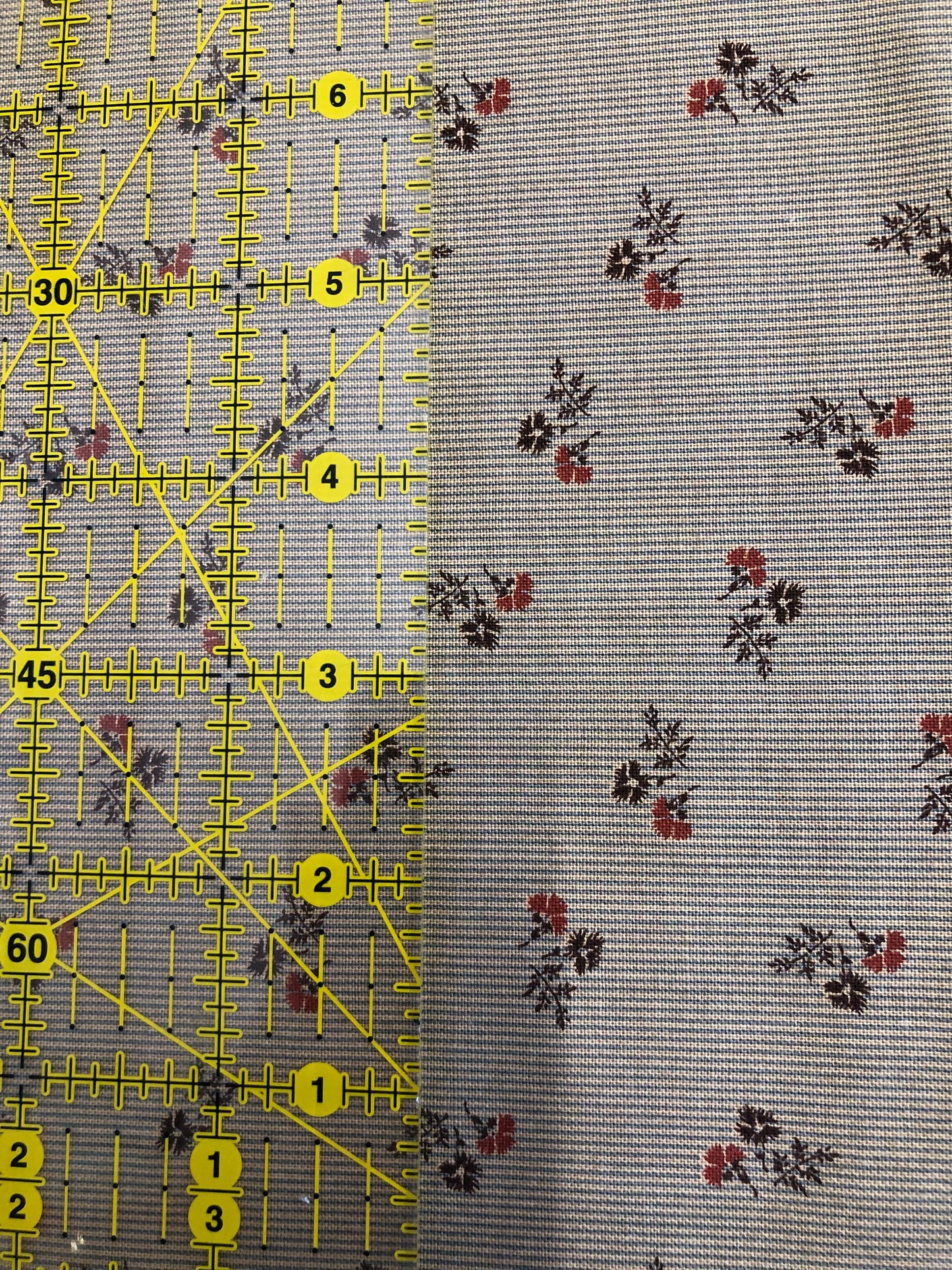 Jo Morton fabric, red and navy flower sprigs on pale blue fine stripe, beside a ruler in inches