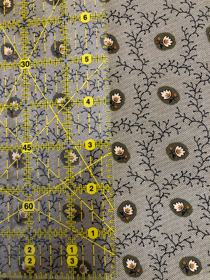 Jo Morton fabric, dark vines with olive and cream flowers on soft grey, beside a ruler in inches