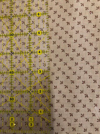 Jo Morton fabric, tiny brown sprigs on pale cream check, beside a ruler in inches