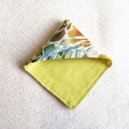 A finished Bookmark Corner: a folded fabric triangle that slips over the corner of a page