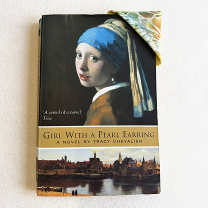 A Bookmark Corner in use on the corner of a paperback