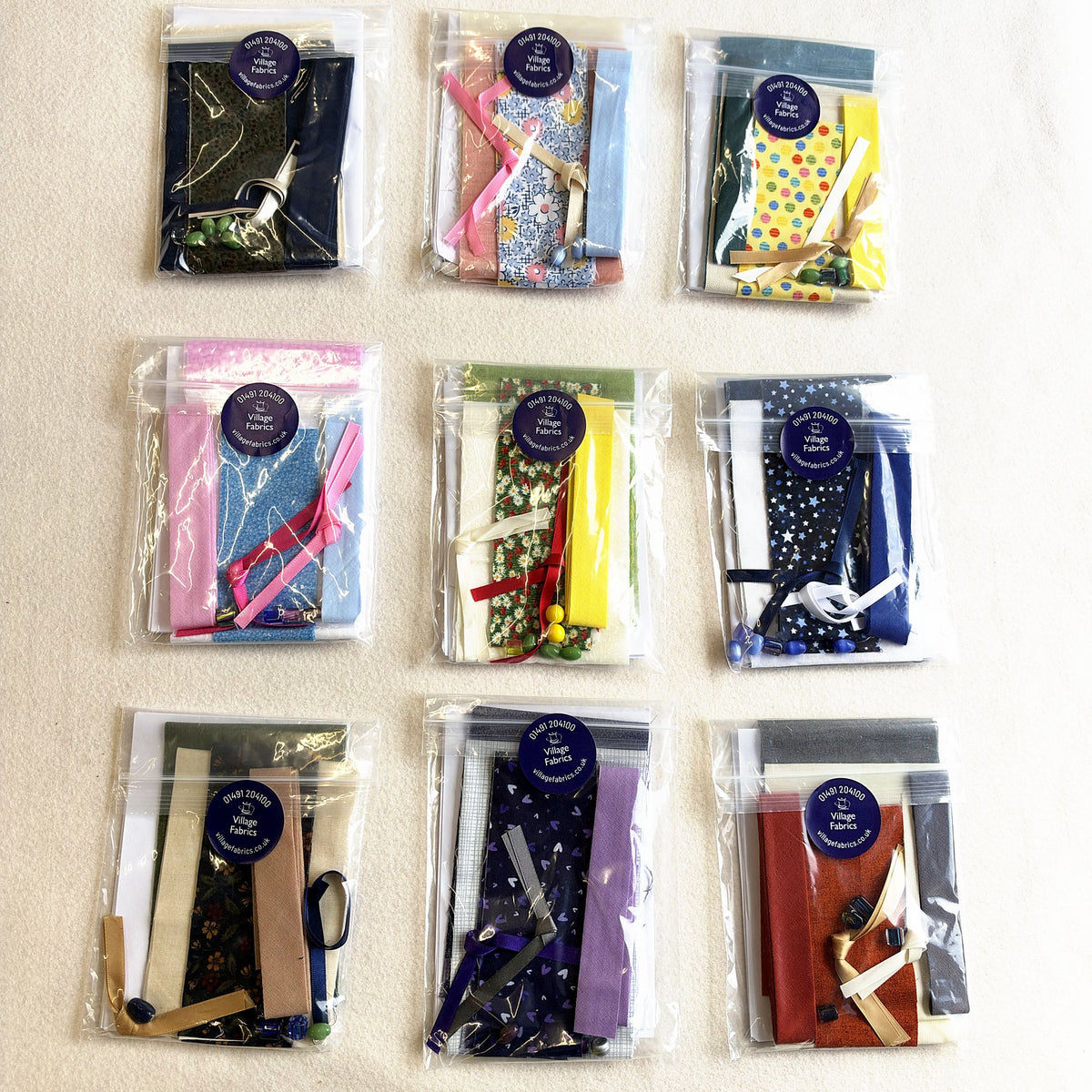 Nine Flying Geese Bookmark kits, each with its own mix of fabrics, ribbon and beads