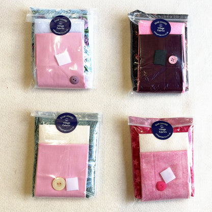 Needle Nest kits in assorted fabrics, each with a button and a hook and loop fastening