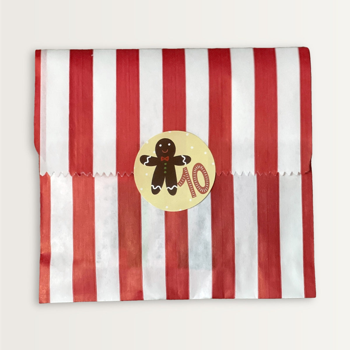 Bag 10 of the Quilter's Advent Calendar, a red and white striped bag sealed with a numbered gingerbread sticker