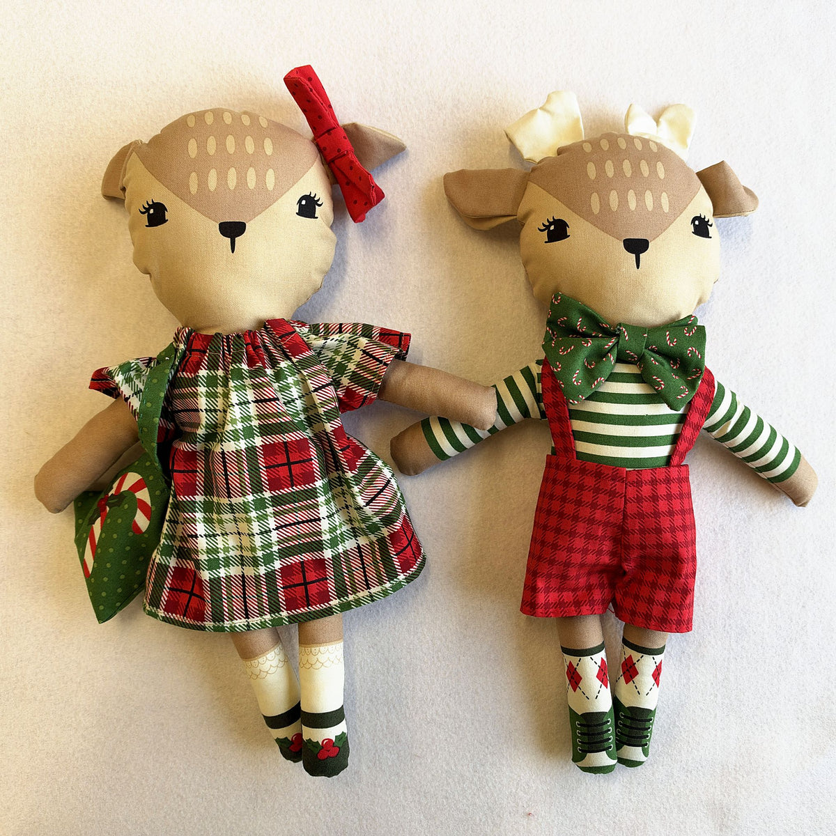 The Reindeer Twins made up from the panel: a girl in a tartan dress with a red bow and a boy in a striped top and red check shorts