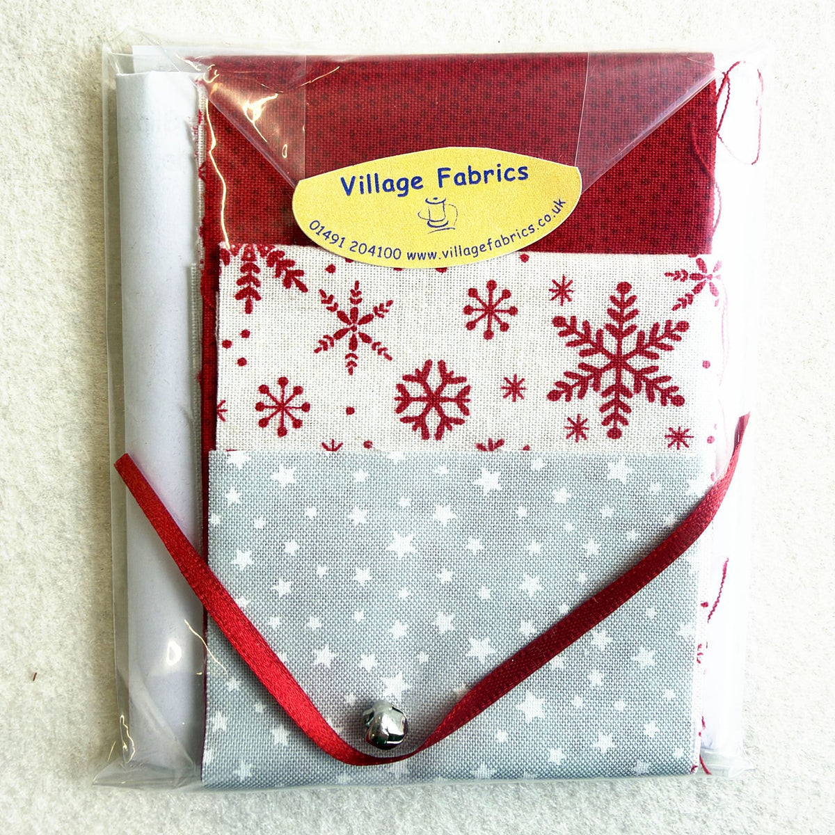 Tiny Folded Christmas Tree kit in the Scandi colourway: grey star, white snowflake and red fabrics with a red hanging ribbon and a bell
