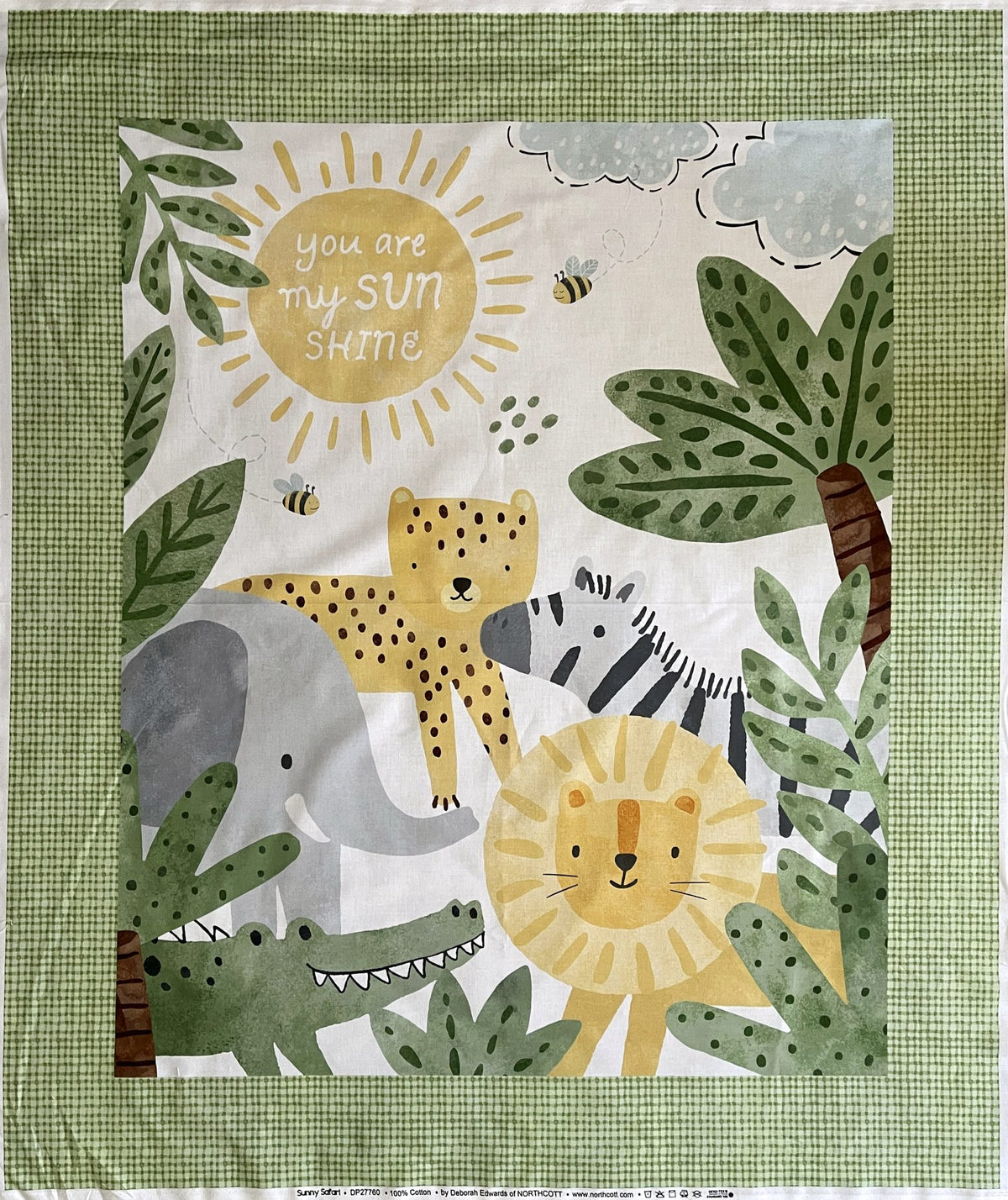 The You Are My Sunshine Cot Panel: a smiling sun, jungle animals and palm leaves in a green gingham border