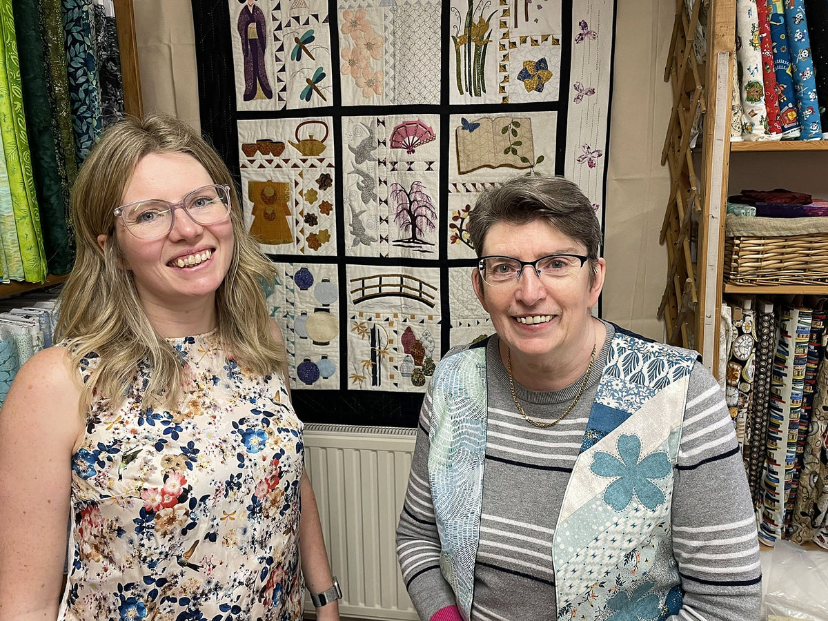Helen and Yvonne in the shop in front of Yvonne's Impressions of Japan quilt